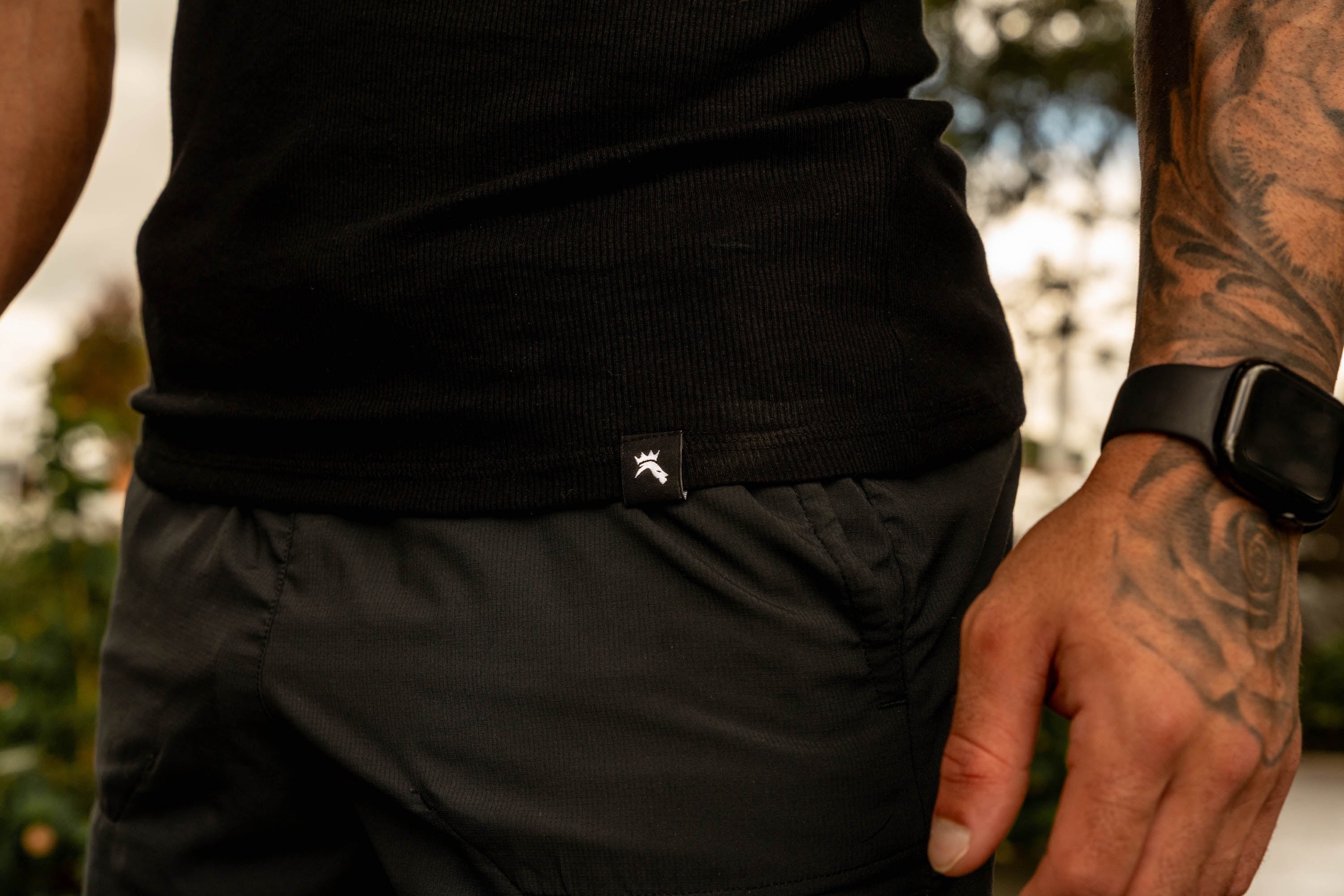 close up of LionBuilt athletic black tank top by water
