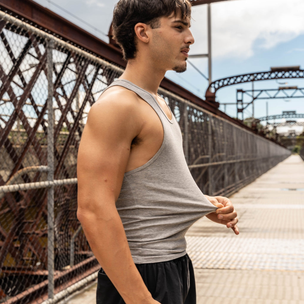 man stretching lionbuilt tank to show off premium cotton blend